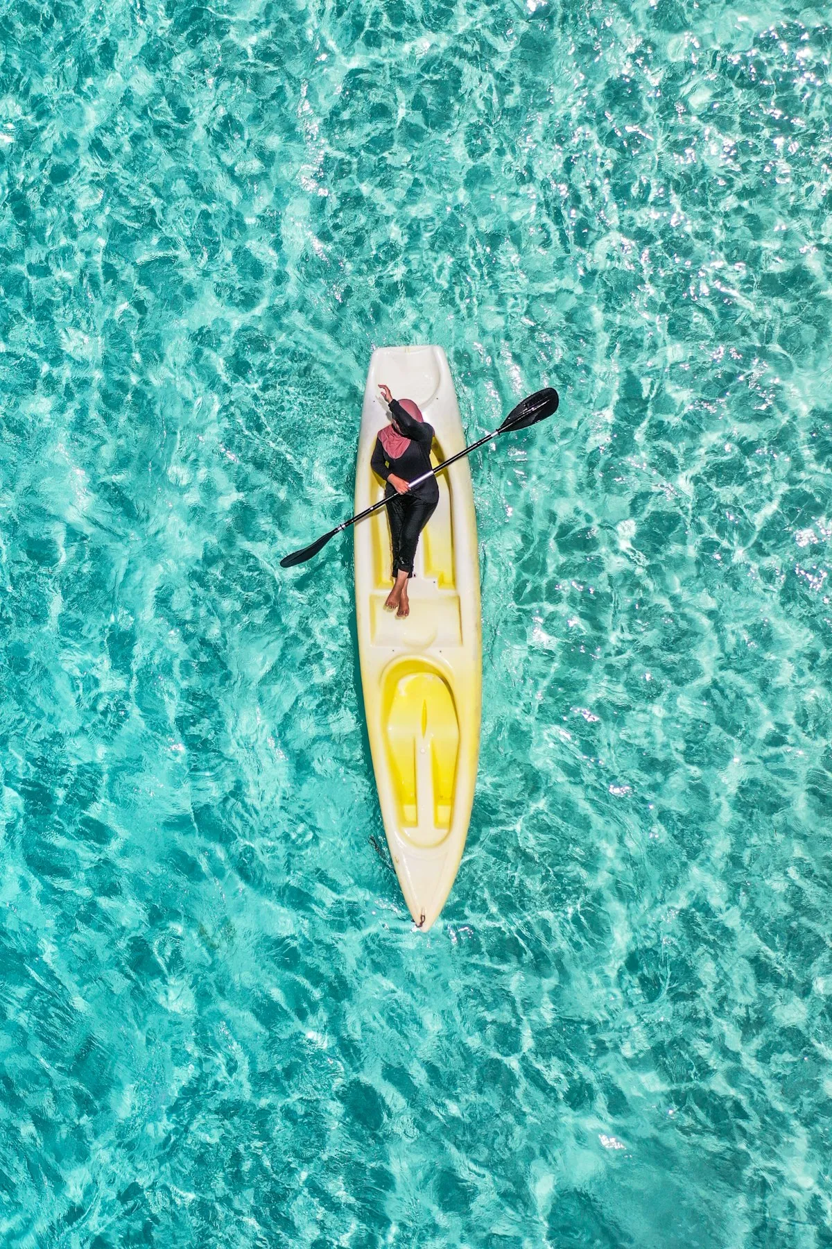 Kayaking through clear turquoise coastal waters